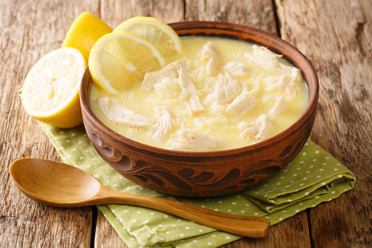 Avgolemono chicken soup with lemon slices in a bowl