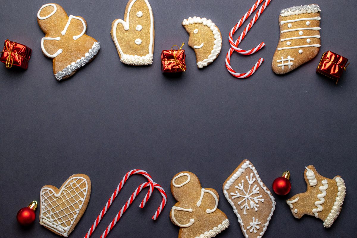 Iced gingerbread medenjaci cookies in festive shapes on a dark background