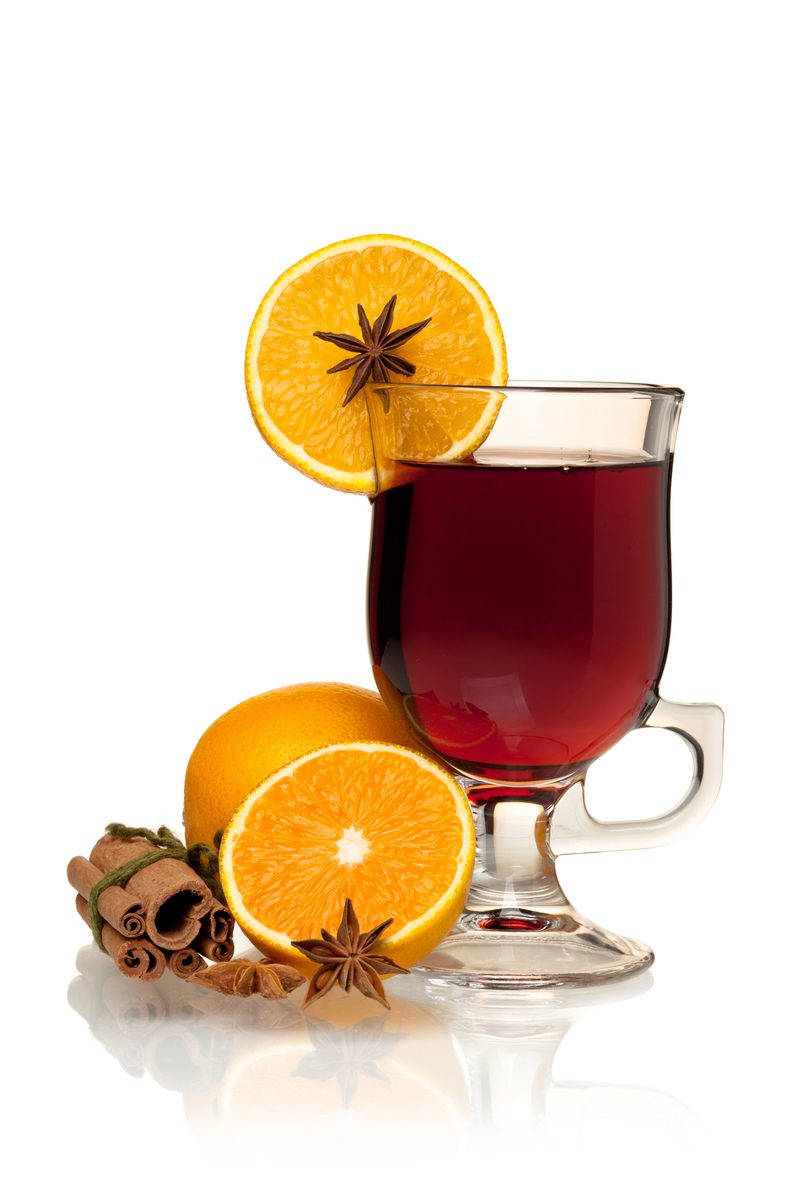 Glass of mulled wine with orange slices, star anise and cinnamon