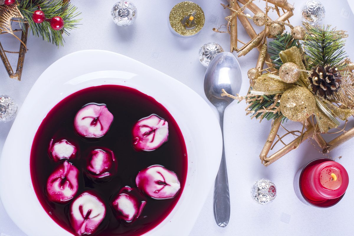 Clear red barszcz beet soup with small mushroom uszka dumplings