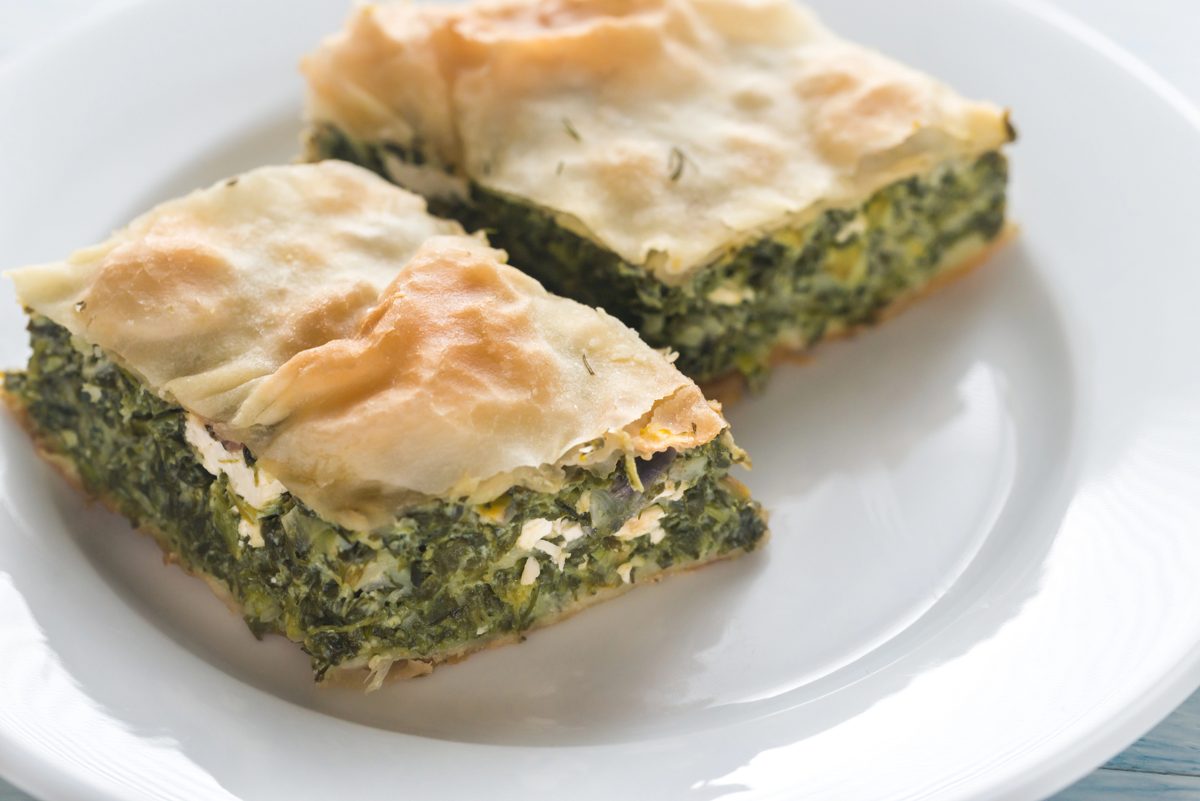 Squares of spinach and feta pie with flaky phyllo pastry