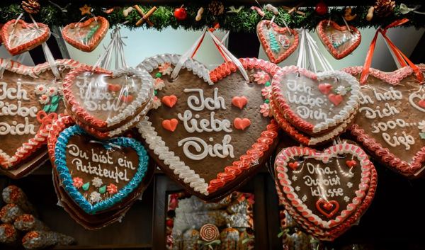 Heart-shaped Lebkuchen with iced lettering hanging at a German Christmas market stall
