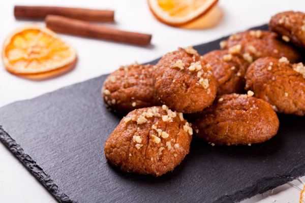 Melomakarona honey cookies sprinkled with chopped walnuts
