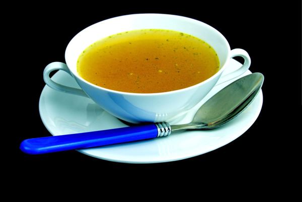 Bowl of clear golden beef soup