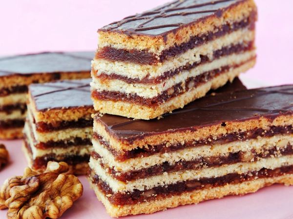 Squares of zserbó, layered walnut and apricot cake with chocolate glaze