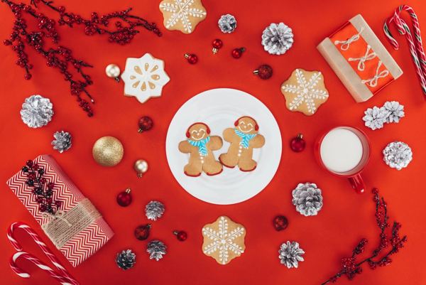Iced gingerbread men and star cookies on a red festive background