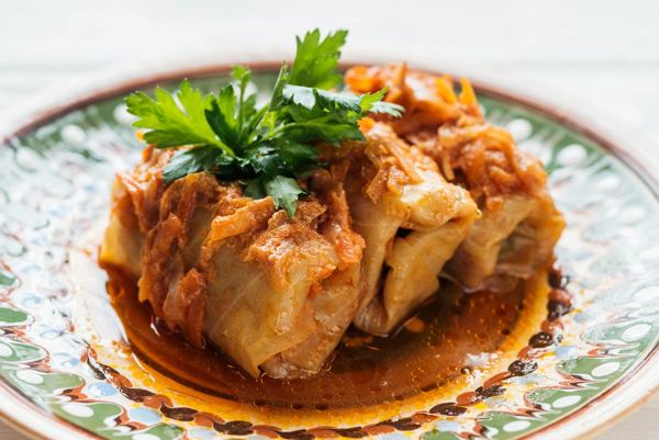 Close-up of gołąbki stuffed cabbage rolls on a decorated plate