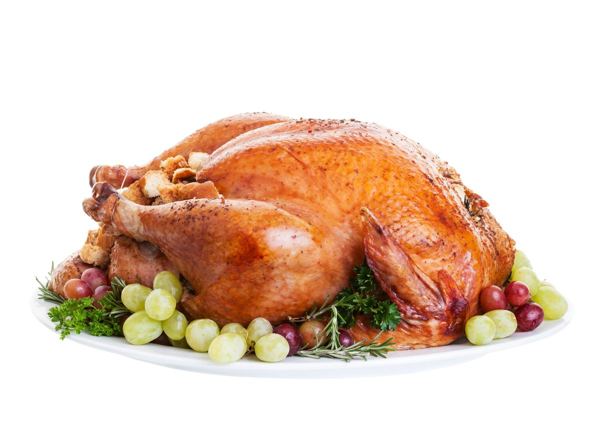 Whole roast turkey on a platter garnished with grapes