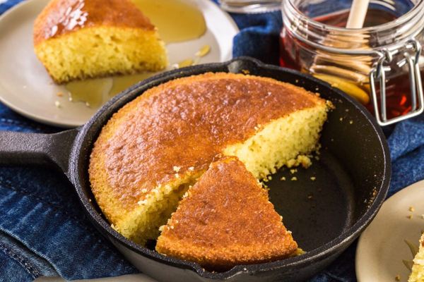 Proja cornbread in a cast iron pan, sliced