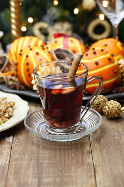 Glass of Swedish glögg with orange and spices on a festive table