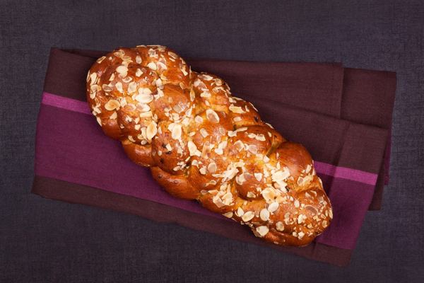 Braided Slovak vianočka bread on a dark cloth