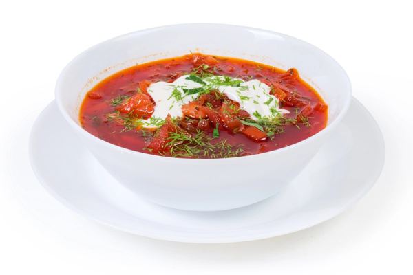 Red beet borshch with sour cream in a white bowl
