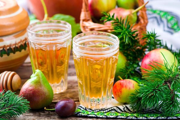 Glasses of uzvar, a drink of dried and smoked fruit, with apples