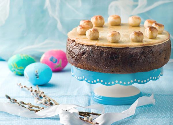 Simnel cake decorated with eleven marzipan balls on a cake stand