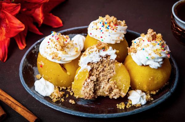 Poached apples stuffed with walnuts and topped with whipped cream