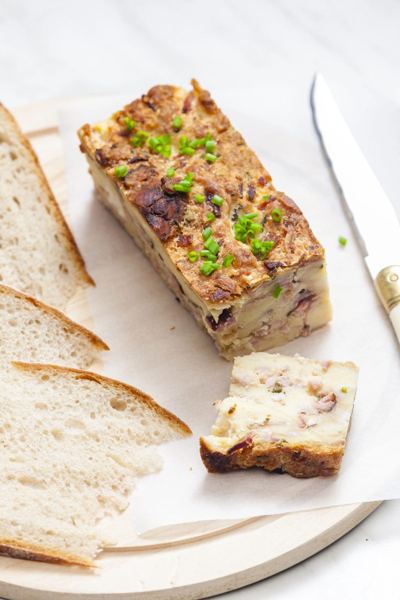 Slice of Easter bread and smoked meat bake with chives