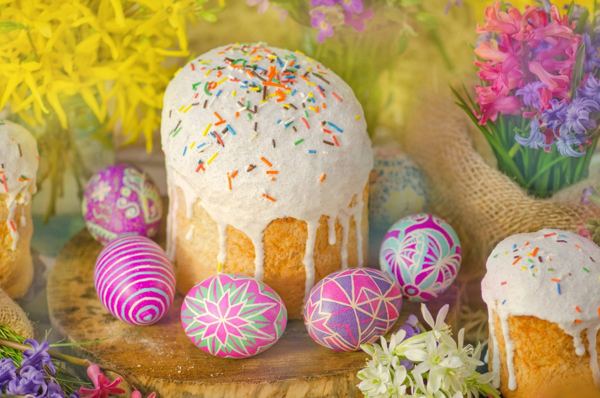 Paska Easter bread with white icing and decorated pysanky eggs