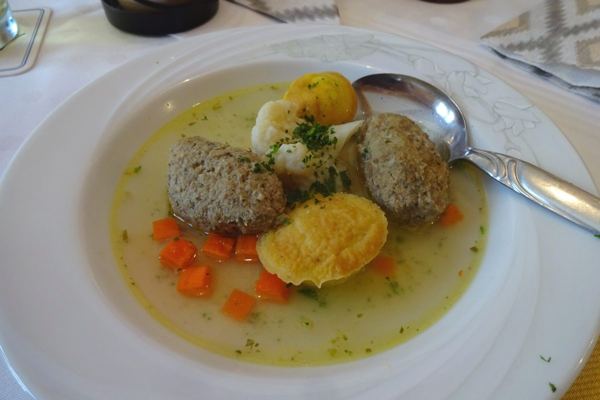 Clear wedding soup with liver dumplings, egg custard, cauliflower and carrots