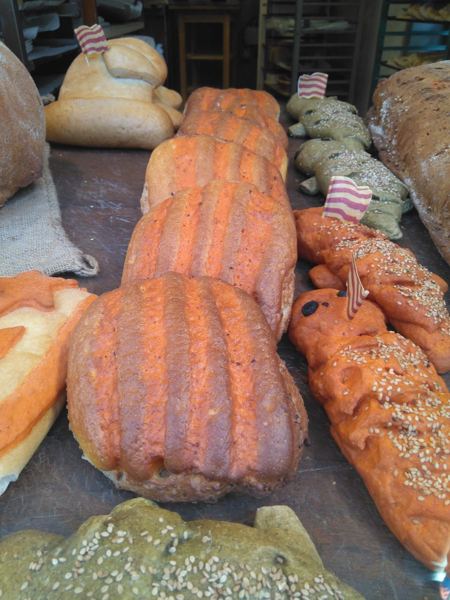 Pa de Sant Jordi bread with red and yellow stripes in a bakery