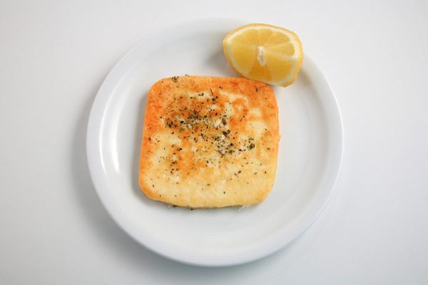 Pan-fried saganaki cheese with lemon