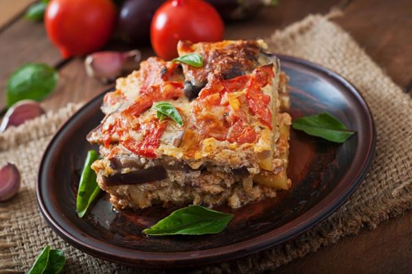 Slice of moussaka with tomato topping
