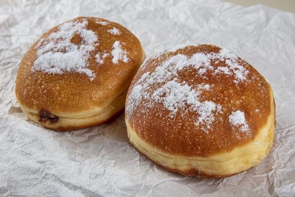Pączki doughnuts dusted with powdered sugar