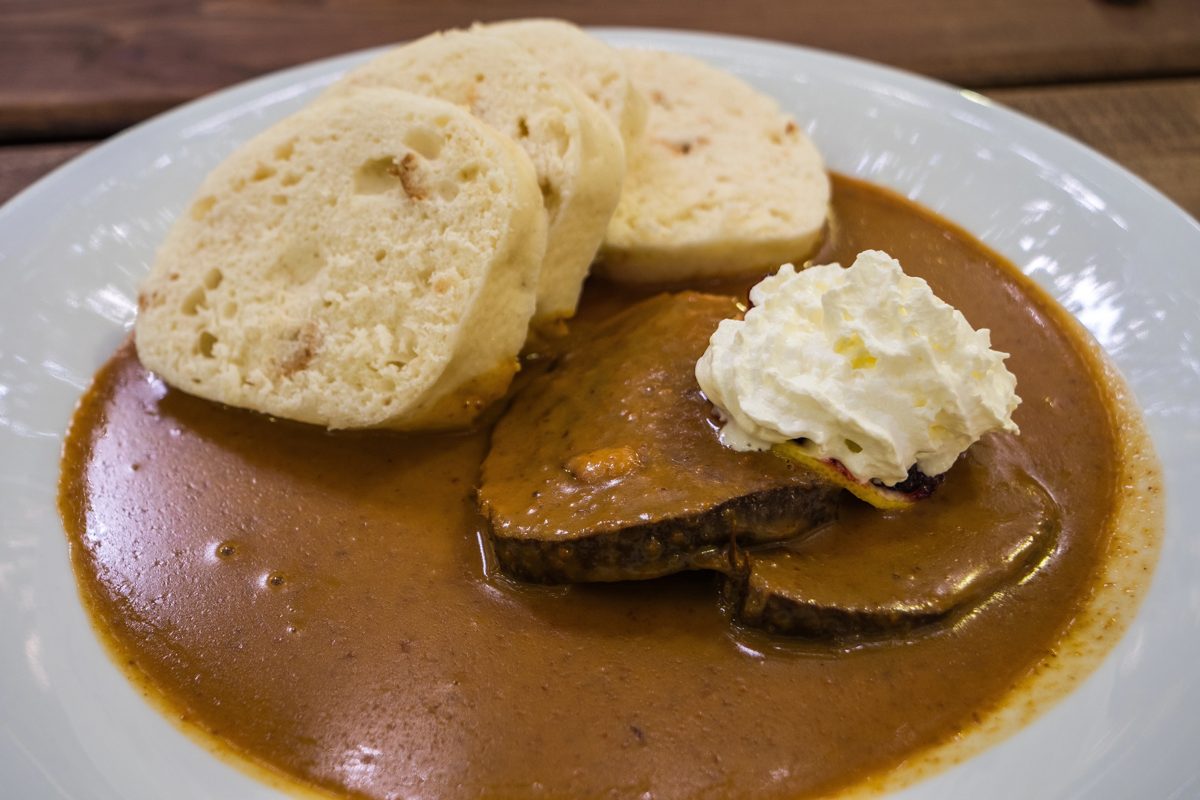 Svíčková beef in cream sauce with bread dumplings and whipped cream