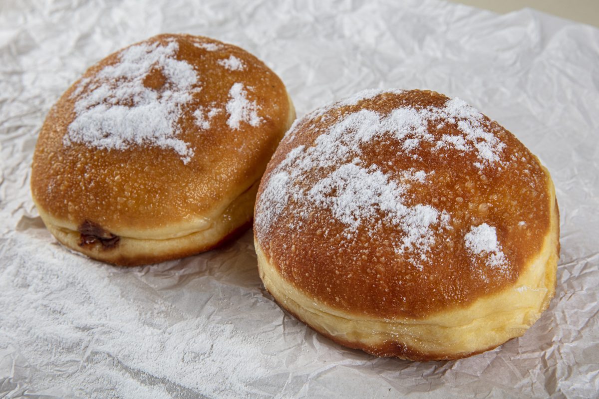 Pączki doughnuts dusted with powdered sugar